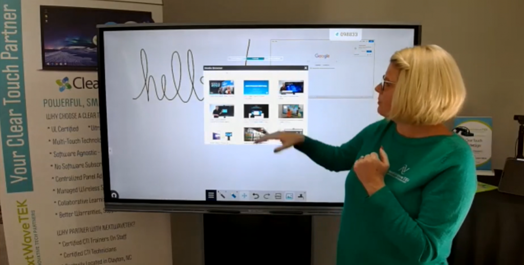 Woman pointing at screen and selecting from multiple windows. 